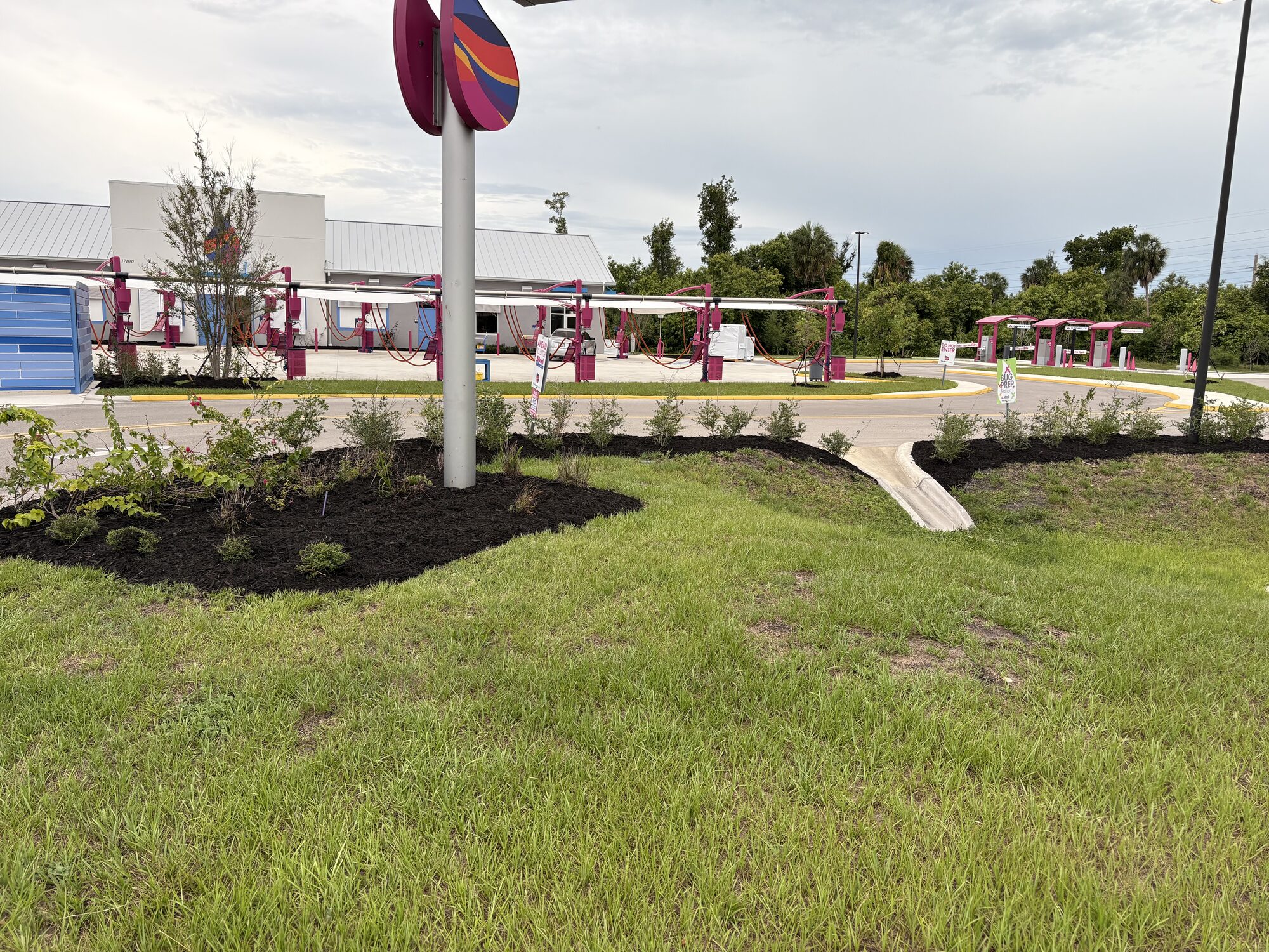 BCQ commercial landscape install at a monument sign entrance in Cape Coral